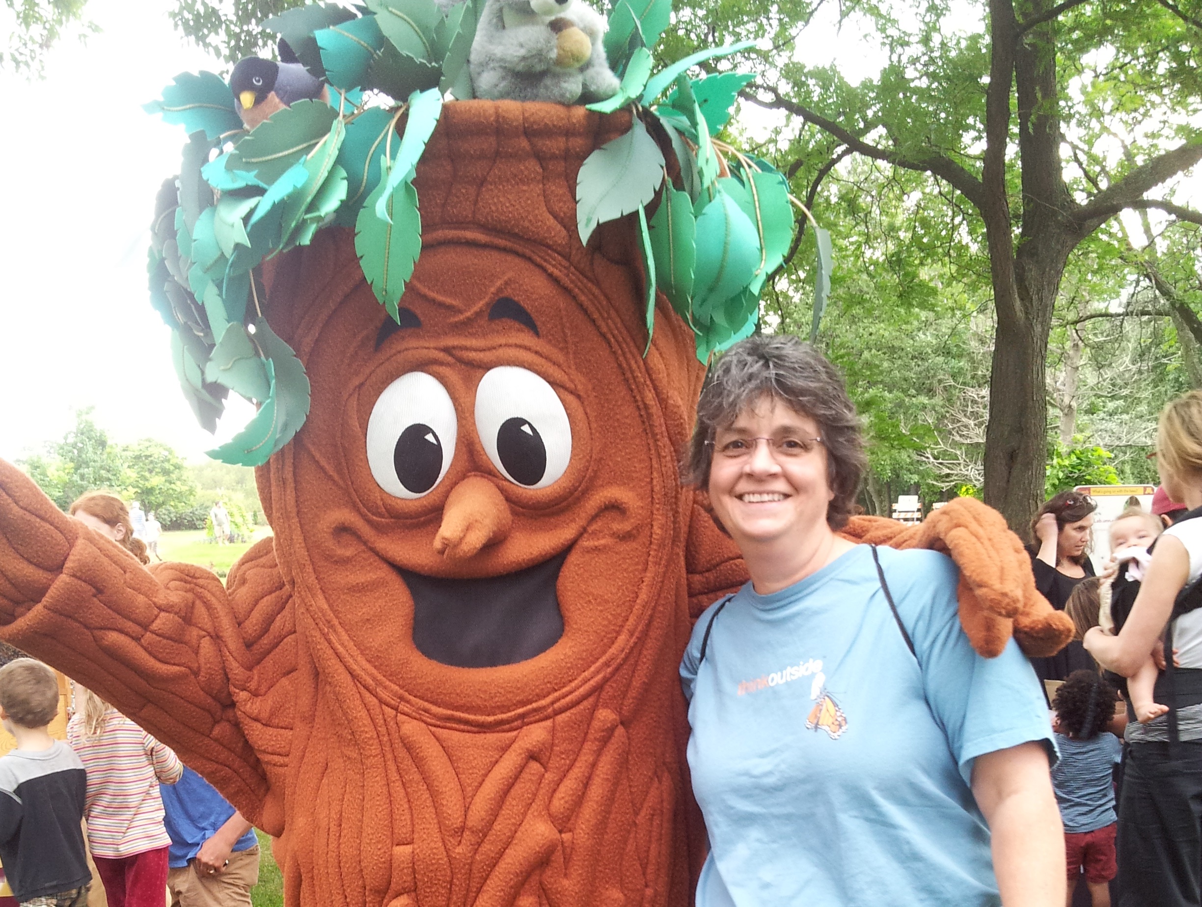 Michelle Kalantari poses with a person dressed in a tree costume.