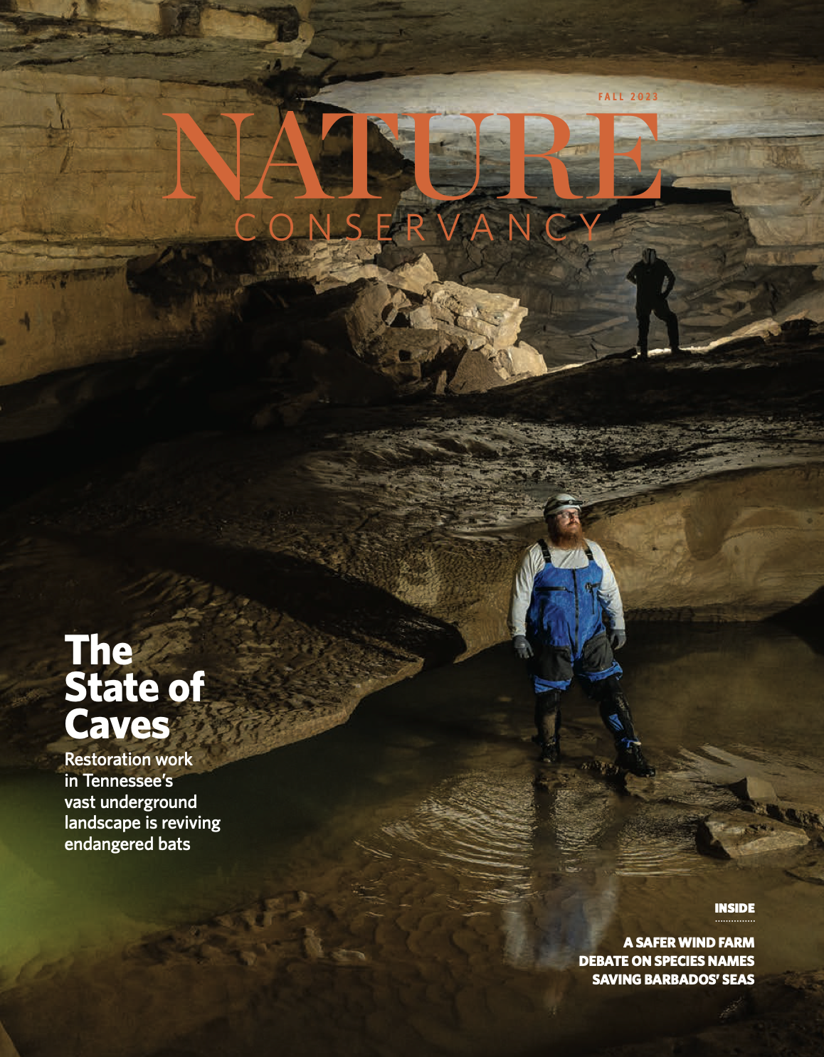 A magazine cover features a man wearing overalls and a headlamp standing in a cave.